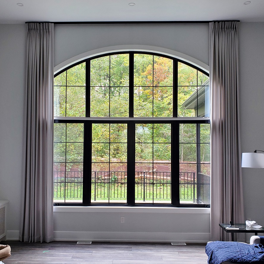 Ceiling mounted hardware over an arched window